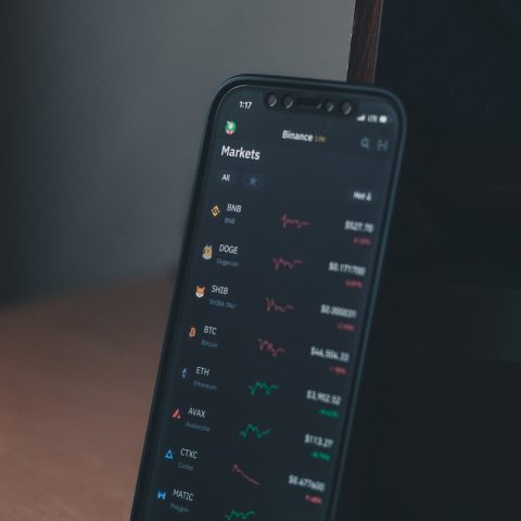 a cell phone sitting on top of a wooden table